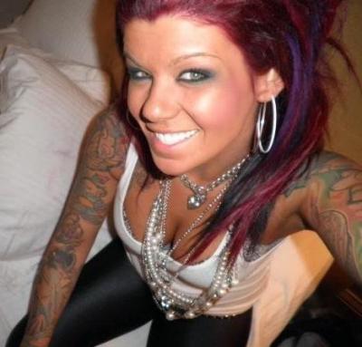 Tattooed chick has two large hoops