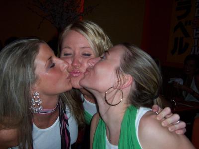3 kissing girls, 1 has hoops ...